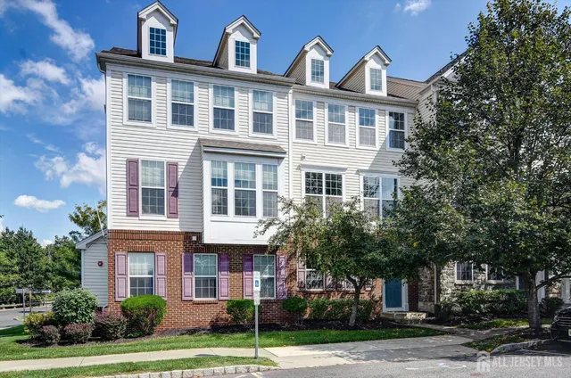 a front view of a building with a garden