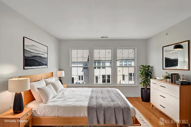 a bedroom with a large bed and a flat screen tv