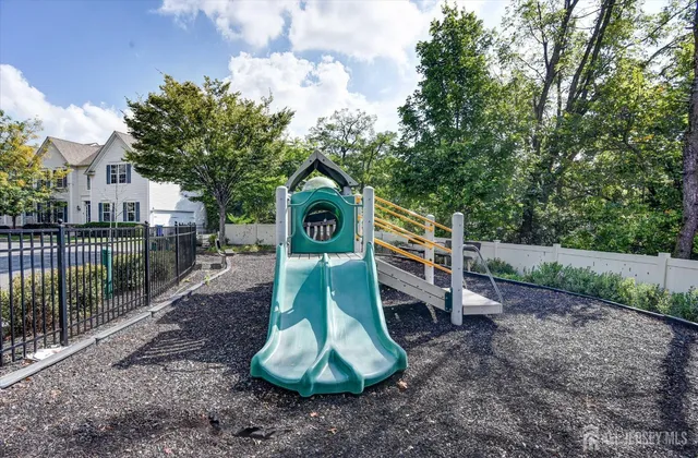a childrens park with lots of swings slides and swimming pool