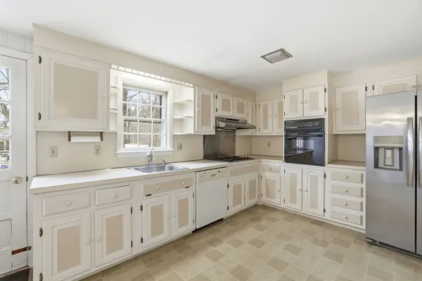 a kitchen with sink and cabinets