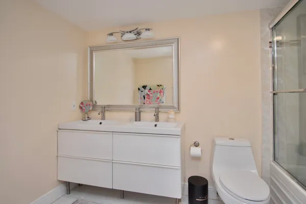 a bathroom with a toilet sink and mirror