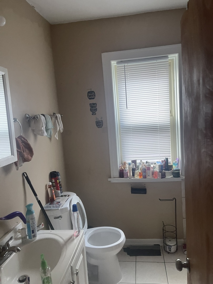 6953 South Artesian Avenue Chicago, IL 60629 - Photo 12 of 23 a bathroom with a sink mirror and toilet