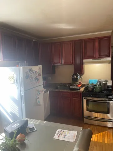a kitchen with a stove and a refrigerator