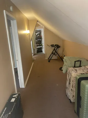 a view of a livingroom with water heater and car parked