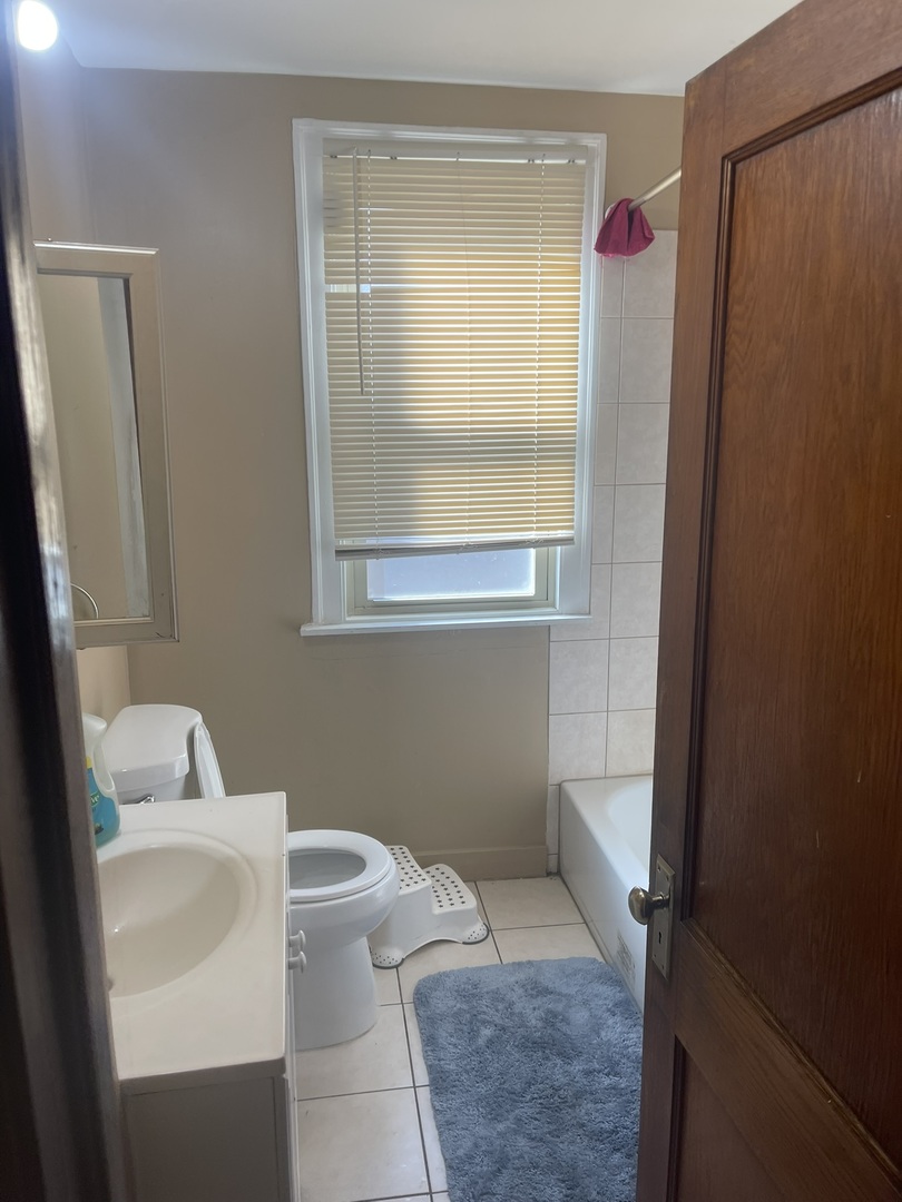 6953 South Artesian Avenue Chicago, IL 60629 - Photo 5 of 23 a bathroom with a toilet and a sink