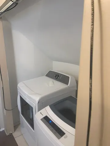 a room with water heater and a cabinet