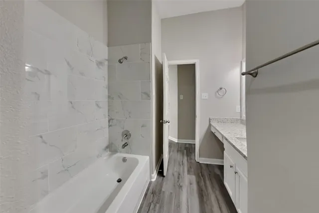 a bathroom with a bathtub and a shower