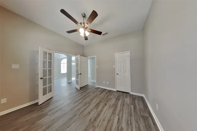 wooden floor in an empty room with a window