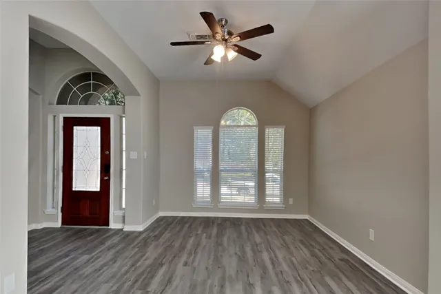 wooden floor in an empty room with a window