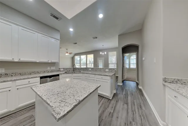 a kitchen with a sink stove and cabinets