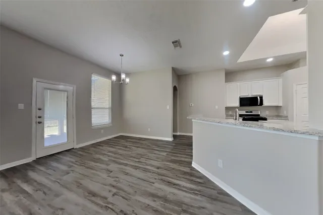 a view of kitchen with microwave and refrigerator