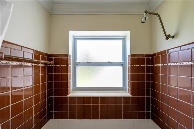 a bathroom with a sink a window and a mirror