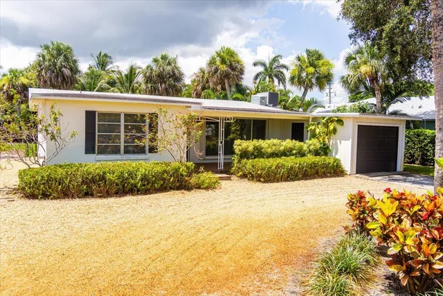 an aerial view of a house with a garden and swimming pool