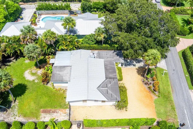 an aerial view of a house with a yard and garden