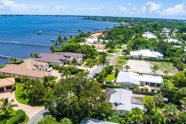 an aerial view of residential houses with outdoor space and street view
