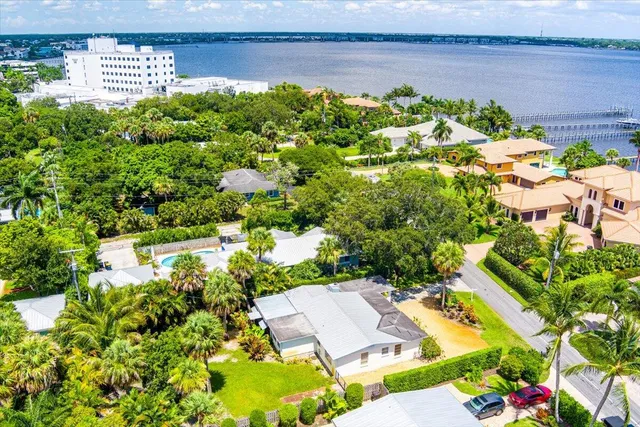 an aerial view of a house with a yard and lake view
