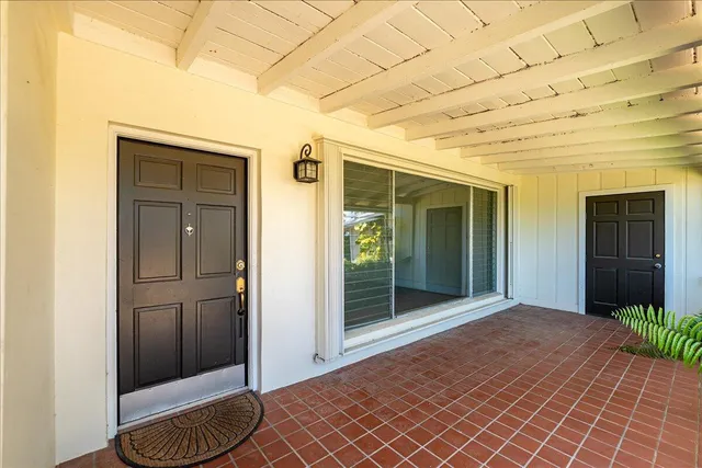 a bedroom with sliding glass door and glass door