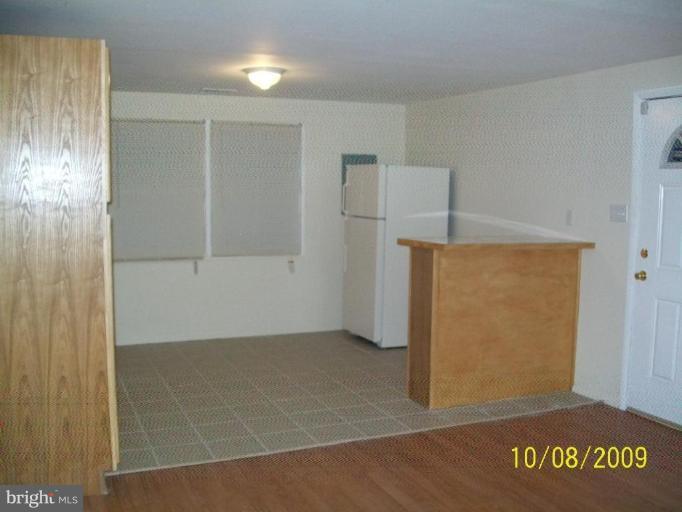 336 Suter Road Catonsville, MD 21228 - Photo 6 of 10 an empty room with an entrance to other room