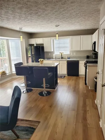 a view of kitchen with granite countertop a sink counter top space and appliances