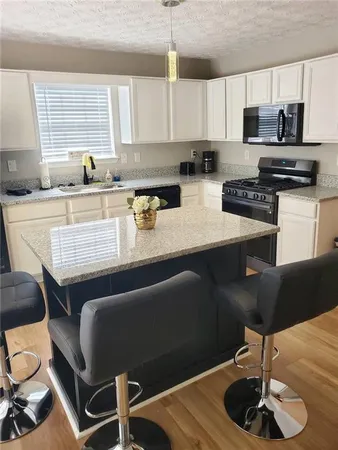 a kitchen with a dining table and chairs