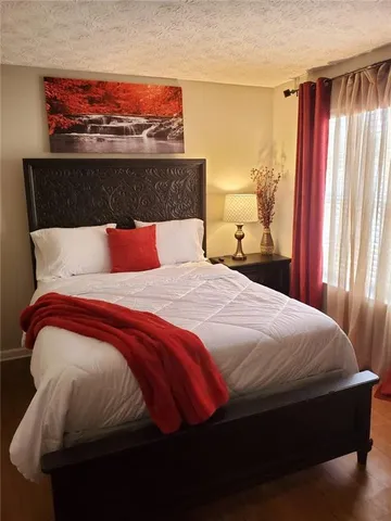 a bedroom with a bed and window