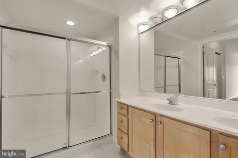 a bathroom with a double vanity sink and mirror