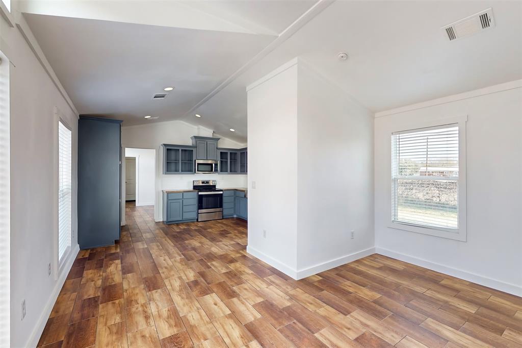 6715 Timberhaven Court Granbury, TX 76049 - Photo 12 of 40 a view of kitchen and living room