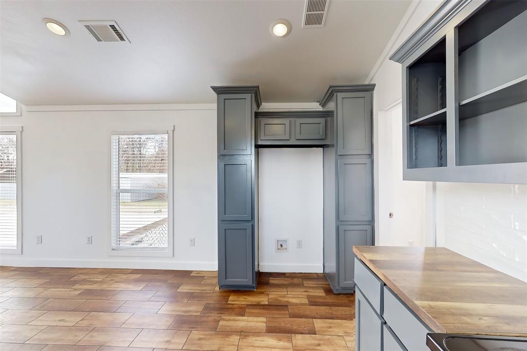 6715 Timberhaven Court Granbury, TX 76049 - Photo 16 of 40 a kitchen that has a cabinets and a stove