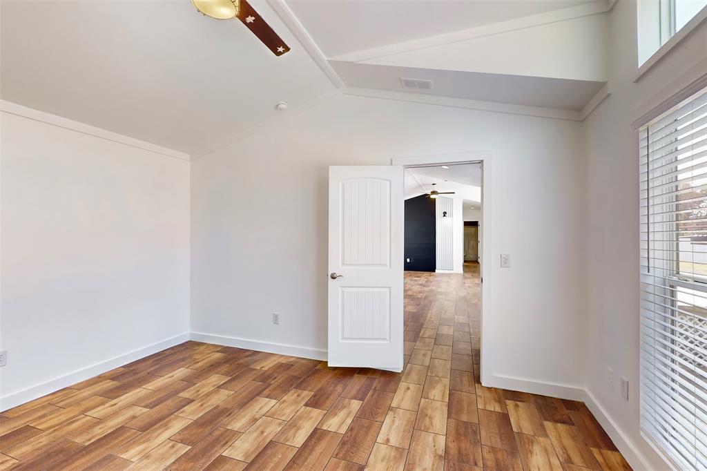6715 Timberhaven Court Granbury, TX 76049 - Photo 24 of 40 a view of hallway with wooden floor and window
