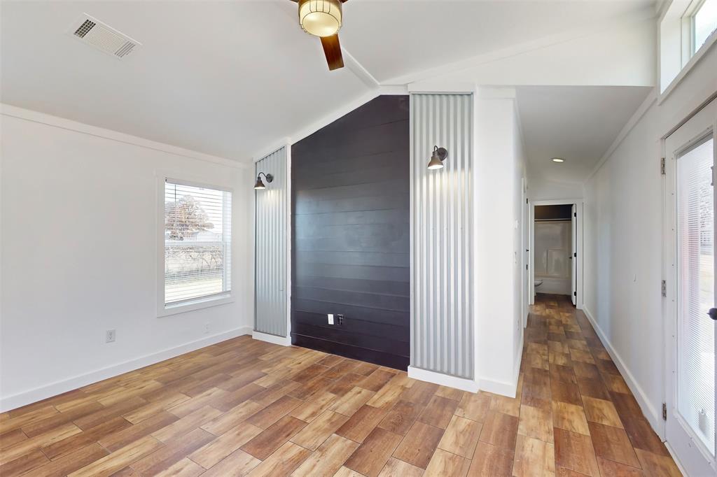 6715 Timberhaven Court Granbury, TX 76049 - Photo 27 of 40 a view of a room with wooden floor and windows