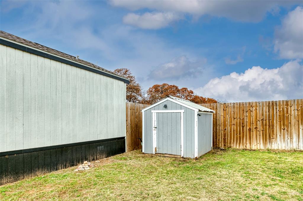 6715 Timberhaven Court Granbury, TX 76049 - Photo 35 of 40 a view of a house with a wooden fence