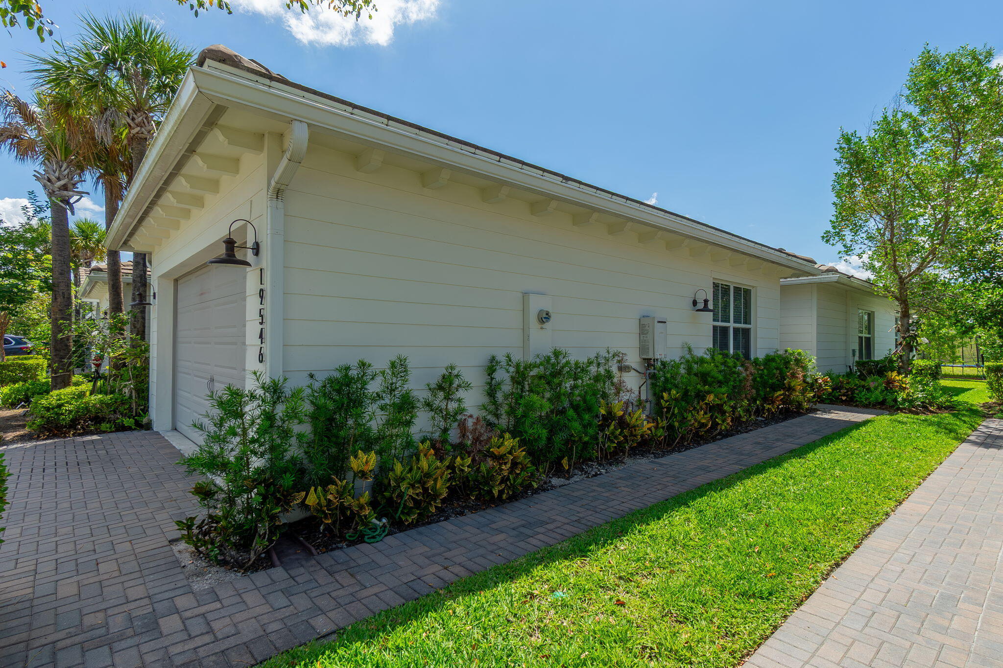 19546 Weathervane Way Loxahatchee, FL 33470 - Photo 4 of 63 a backyard of a house with plants and trees