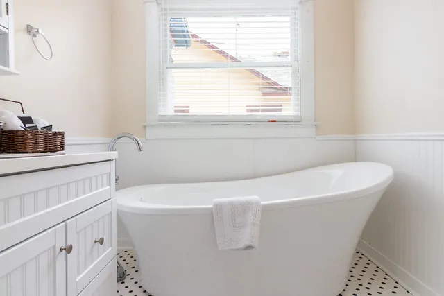 a white bath tub sitting next to a window