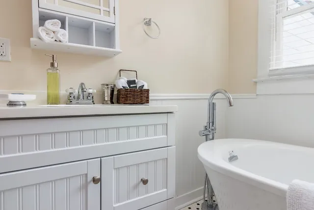a bath tub sitting next to a bathroom sink