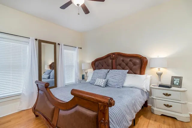 a bedroom with a bed and a chandelier