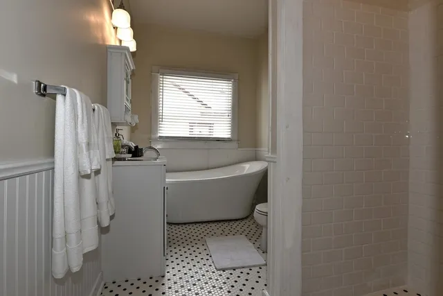 a bathroom with a bathtub and a window