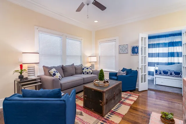 a living room with furniture and a wooden floor