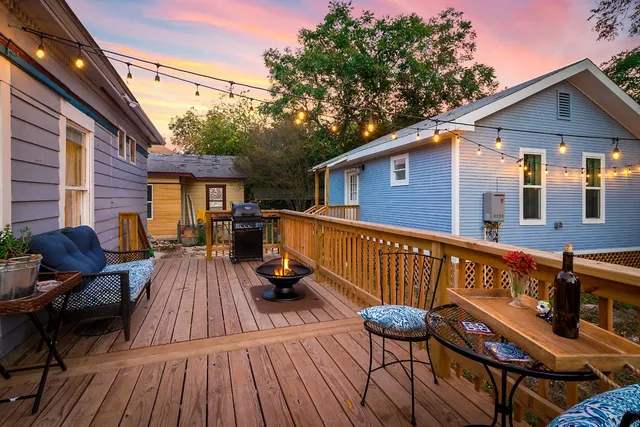 a view of a patio with couches chairs and wooden floor