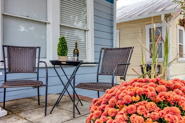 a balcony with table and chairs