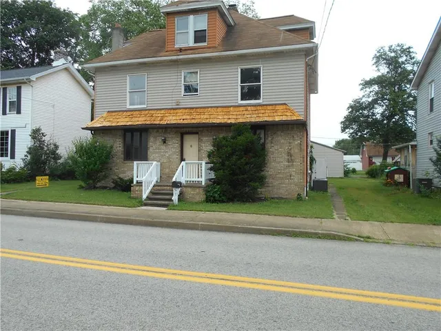 a front view of a house with a yard