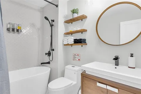 a bathroom with a sink a toilet and a mirror