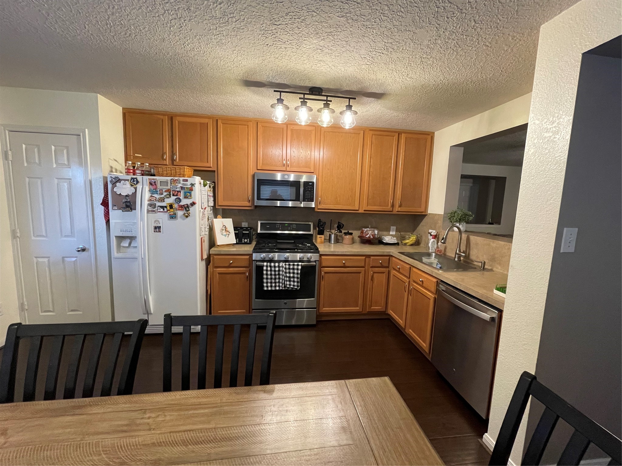 3310 Legends Wild Drive Spring, TX 77386 - Photo 13 of 40 a kitchen with granite countertop a refrigerator stove and sink