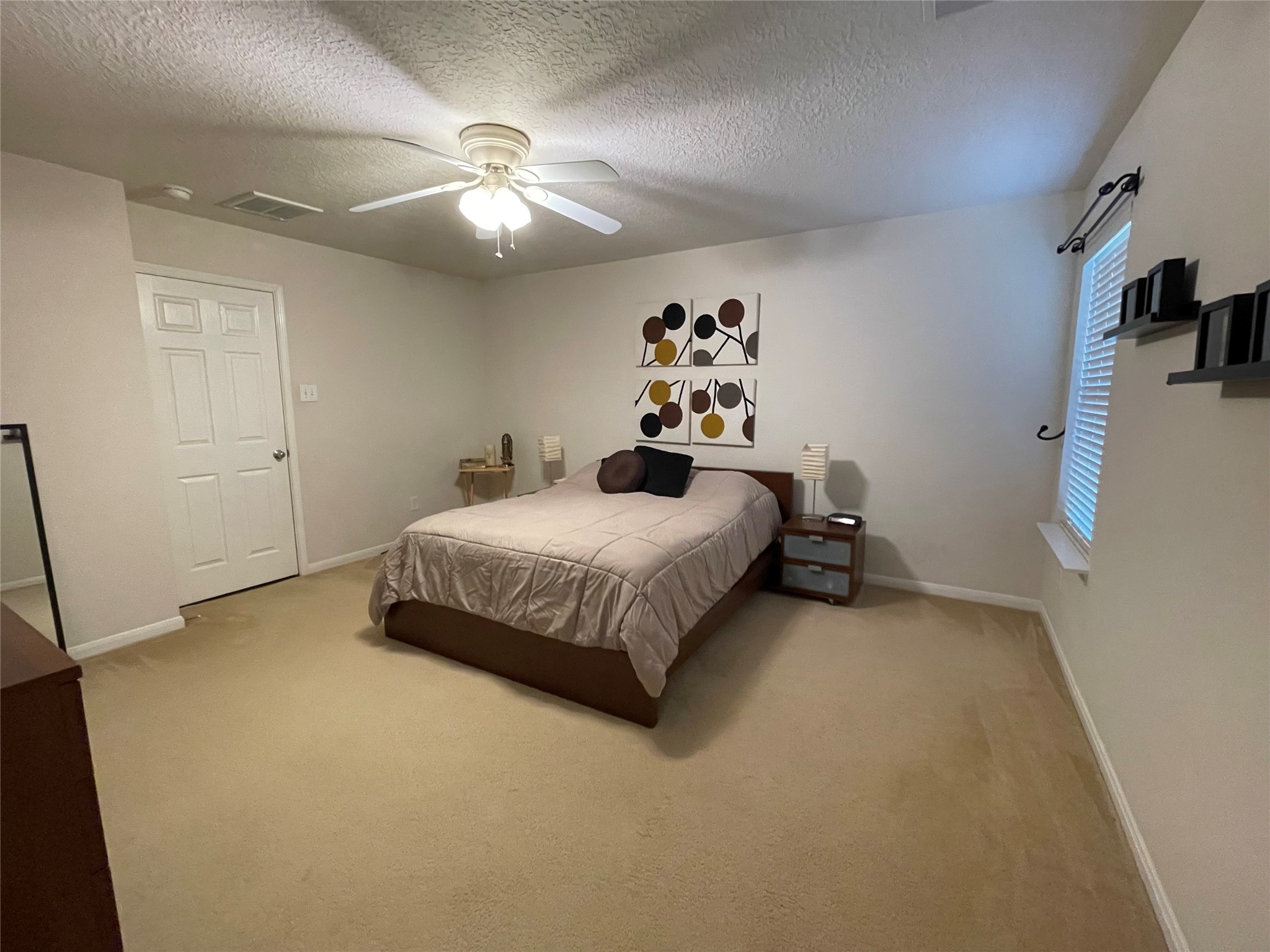 3310 Legends Wild Drive Spring, TX 77386 - Photo 19 of 40 a bedroom with a bed and a chandelier