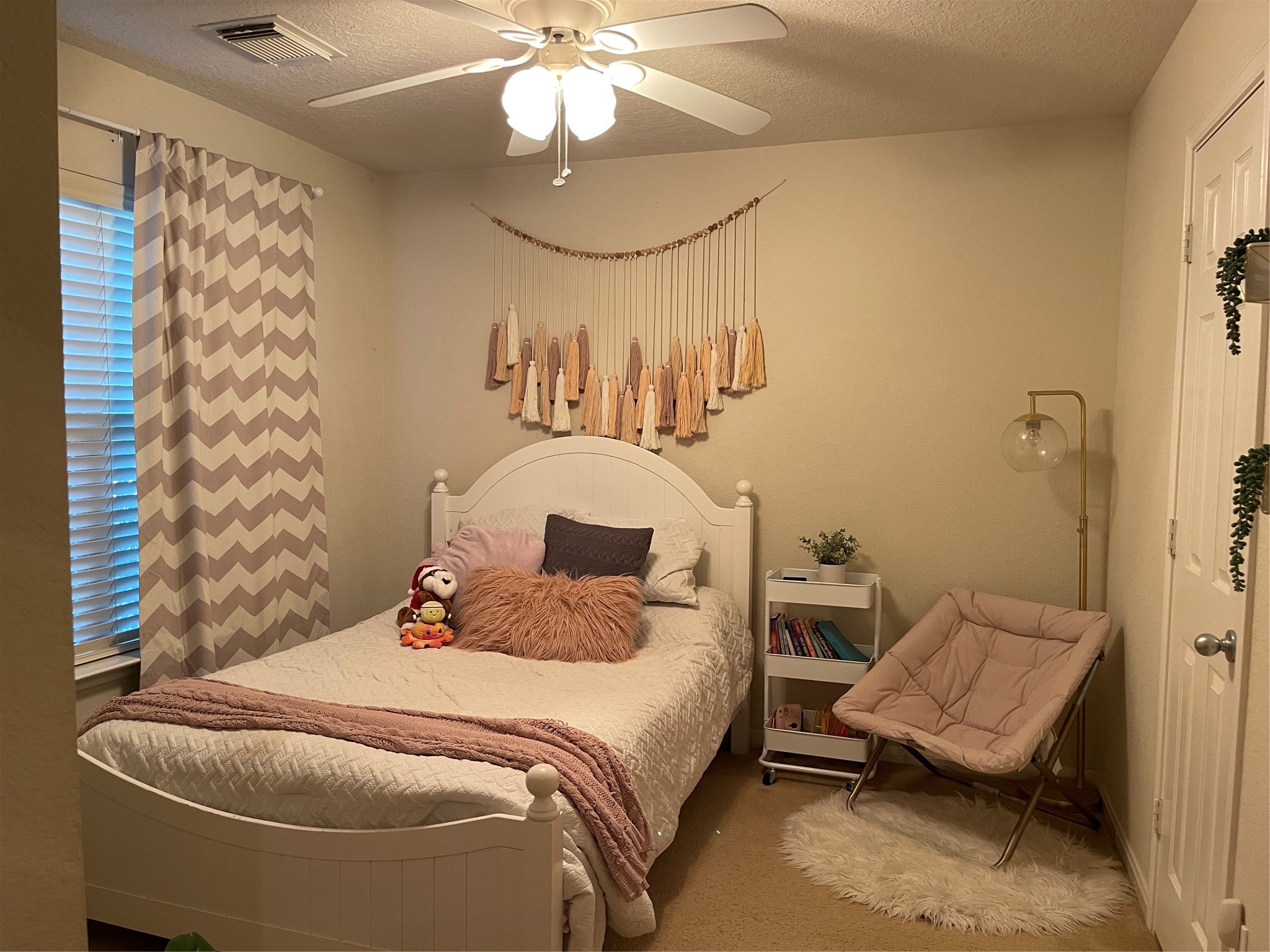 3310 Legends Wild Drive Spring, TX 77386 - Photo 22 of 40 a bedroom with a bed and a chandelier