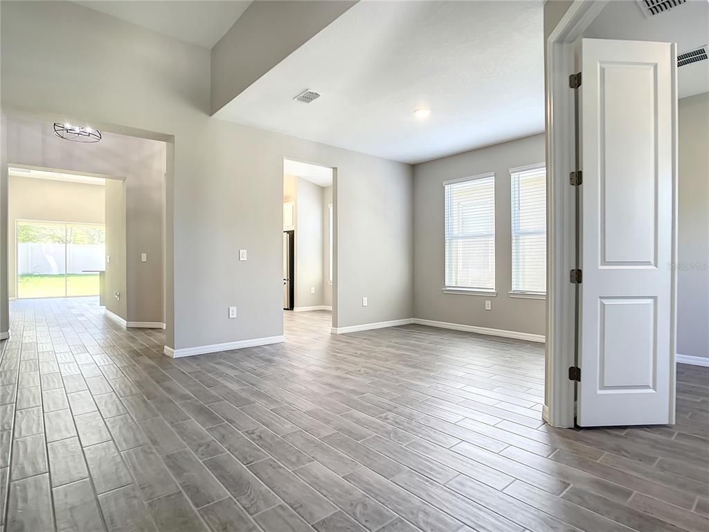 2675 Ridgetop Lane Clermont, FL 34711 - Photo 16 of 56 a view of an empty room with wooden floor and a window
