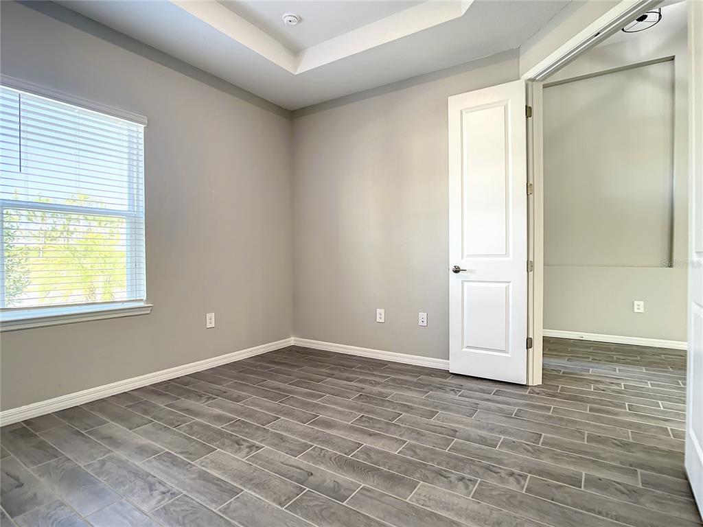 2675 Ridgetop Lane Clermont, FL 34711 - Photo 19 of 56 a view of an empty room with window and wooden floor