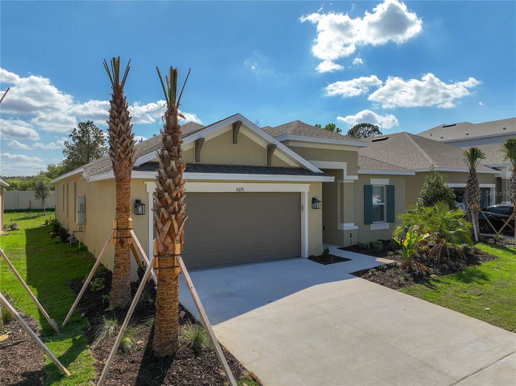 2675 Ridgetop Lane Clermont, FL 34711 - Photo 2 of 56 a front view of a house with garden