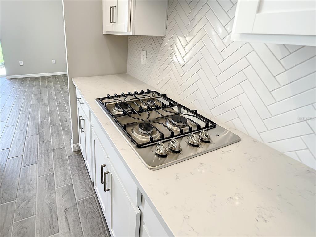 2675 Ridgetop Lane Clermont, FL 34711 - Photo 31 of 56 a kitchen with wooden cabinets and white appliances