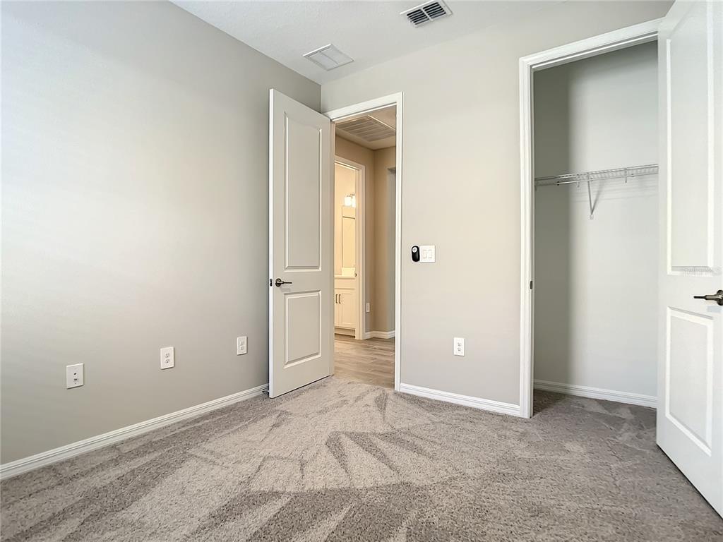 2675 Ridgetop Lane Clermont, FL 34711 - Photo 38 of 56 an empty room with closet and windows