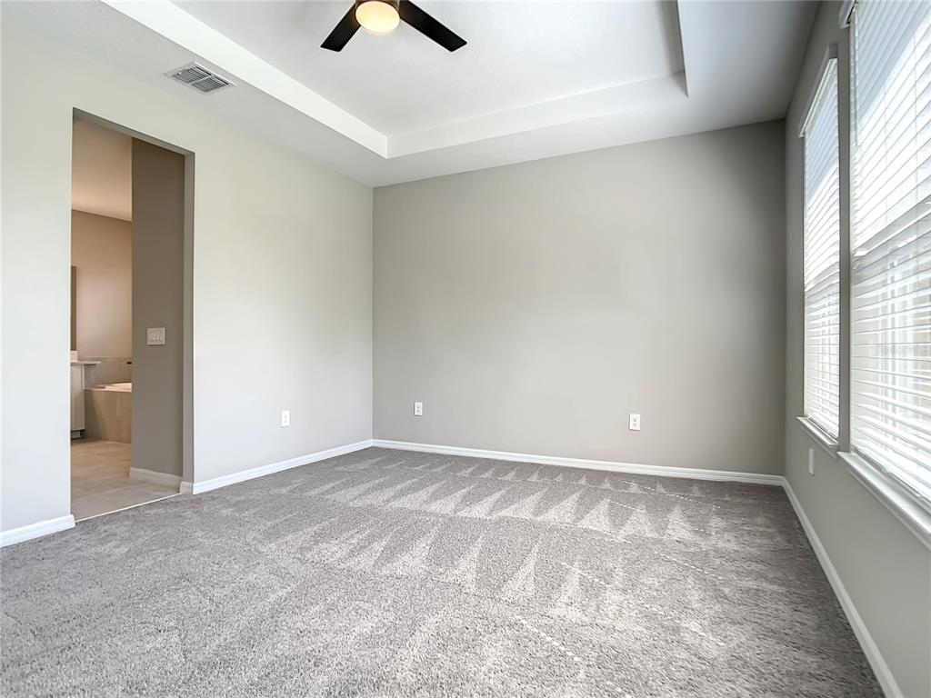 2675 Ridgetop Lane Clermont, FL 34711 - Photo 46 of 56 an empty room with windows and entrance